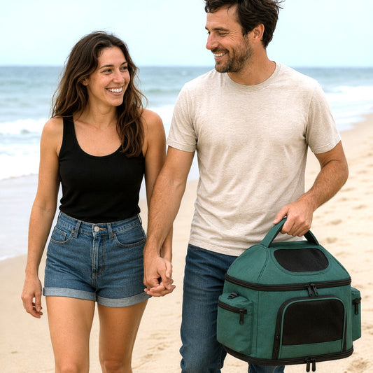 A couple walking hand in hand on the beach with a green Treeho pet carrier